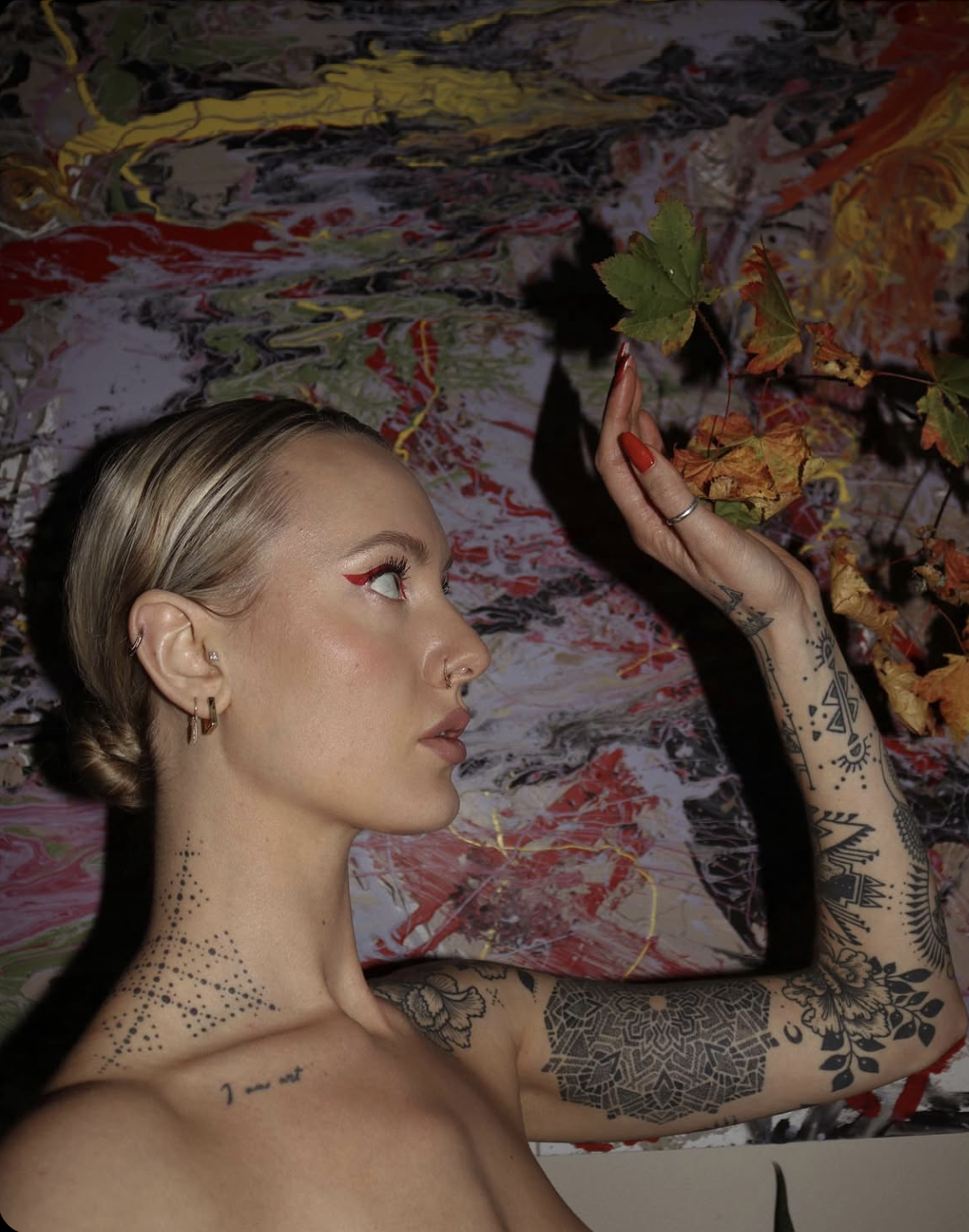Anna Valentina — side profile against abstract painting
